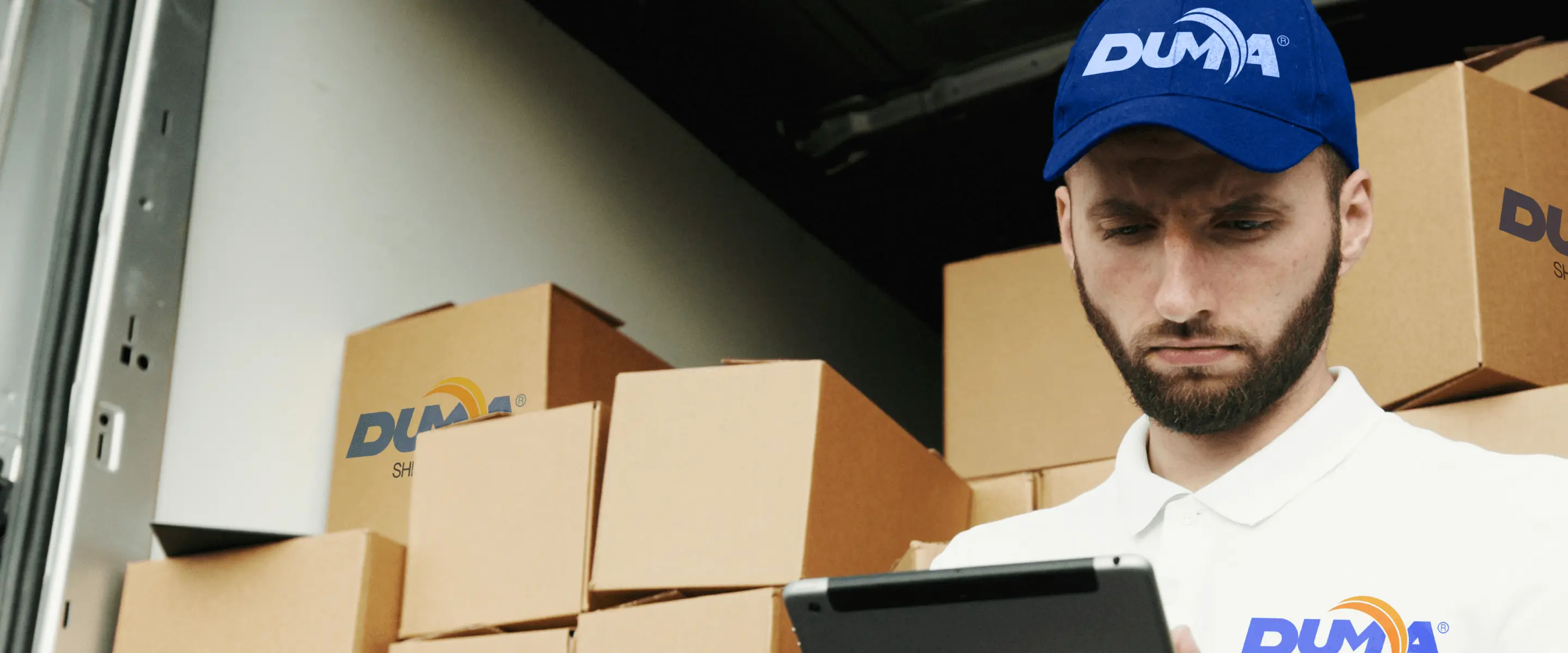 A man loads boxes into a Duma Shipping vehicle